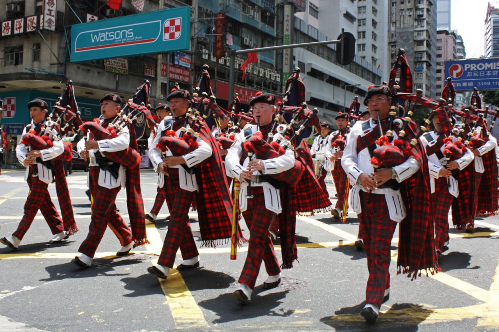 Members of the Hong Kong Police Band march in a parade playing bagpipes and dressed in tartan; two prominent cultural Scottish symbols.(Flickr/istolethetv)