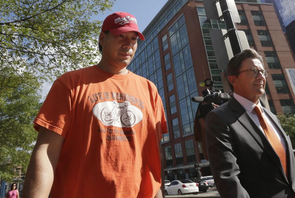 Glenn Adam Chin, seen here on the left with his lawyer after an appearance in federal court in Boston last week, is the first person arrested in connection with a deadly meningitis outbreak linked to a Framingham compounding pharmacy. (Steven Senne/AP)