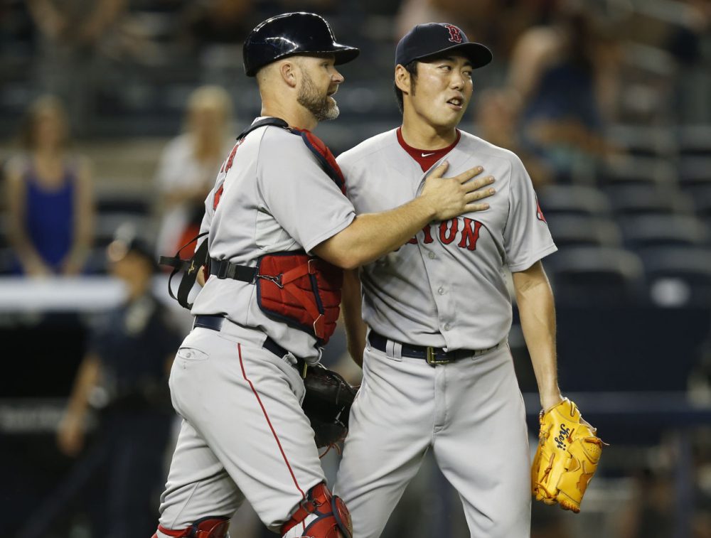 Boston Red Sox catcher David Ross (3) congratulates Boston Red Sox relief pitcher Koji Uehara after defeating the N.Y. Yankees  9-4 Tuesday night. (Kathy Willens/AP)