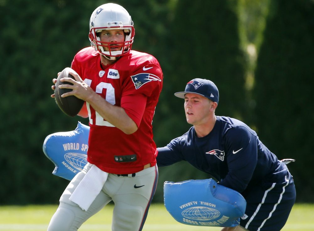 New England Patriots quarterback Tom Brady passes under pressure during a drill at team practice in Foxborough, Mass., Wednesday, Sept. 3, 2014. The Patriots are preparing for their opening NFL football game against the Miami Dolphins on Sunday in Miami. (AP)