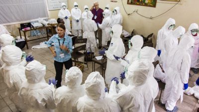 A World Health Organization worker trains nurses on how to use Ebola protective gear in Freetown, Sierra Leone last year. (AP)