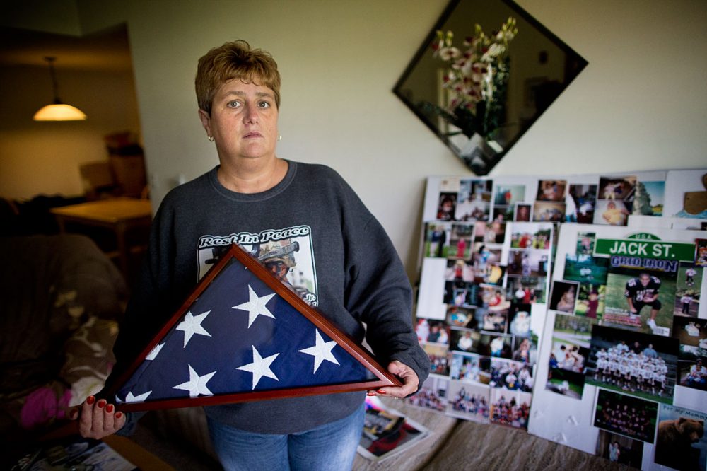 Tammy Sprague Gallagher, whose son, a Massachusetts National Guard soldier, died by suicide last October, stands among tributes to him in her Raynham home. (Jesse Costa/WBUR)
