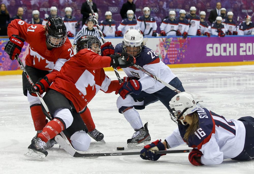 Kelli Stack (16) reaches for the rebound against Canada during overtime of the women's gold medal ice hockey game at the 2014 Winter Olympics. Stack was one of seven players on the U.S. Women's Hockey Team roster who also played for the Boston Blades. (Matt Slocum/AP)
