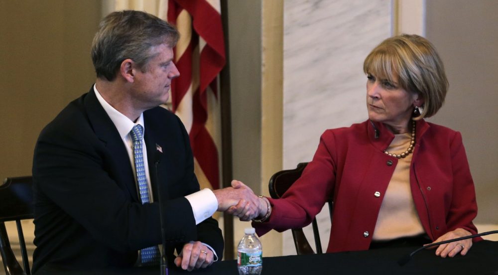 Mass. Republican nominee for governor Charlie Baker, left, shakes hands with Democratic nominee Martha Coakley following a candidates forum at Faneuil Hall on Sept. 24, 2014. (Charles Krupa/AP)
