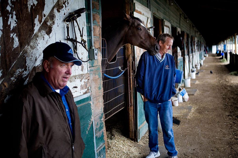 Horse trainer Wayne Marcoux, left, and owner Michael Cook at Suffolk Downs this week (Jesse Costa/WBUR)