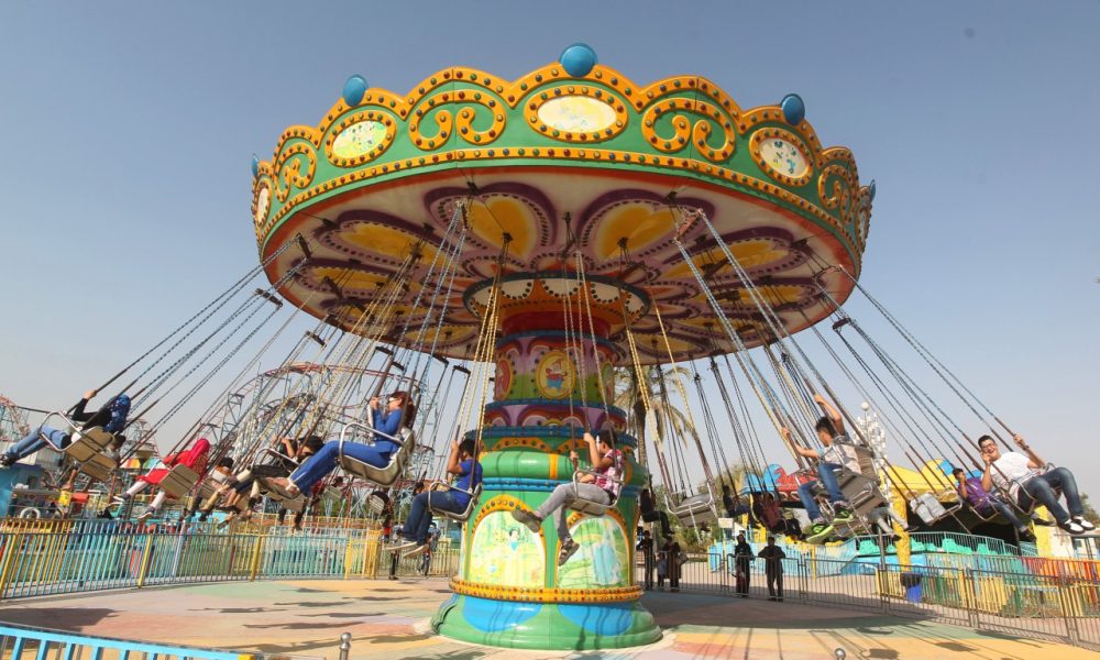 Iraqis take a ride at an amusement park during the Muslim holiday of Eid al-Adha in Baghdad on October 5, 2014. (Ahmad Al-Rubaye/AFP/Getty Images)