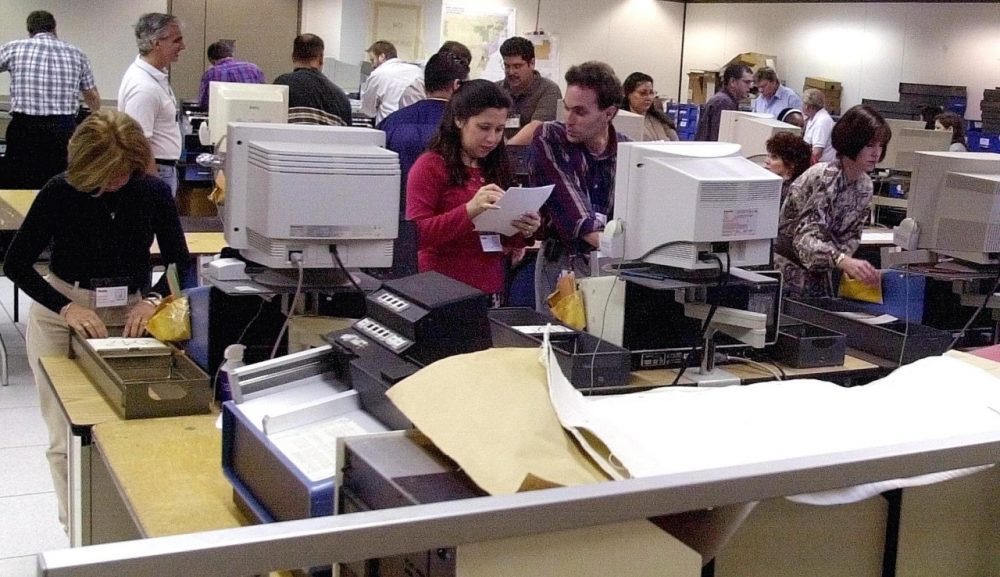 Workers at the Miami-Dade election headquarters in downtown Miami, Florida, recount the ballots of the county November 8, 2000, the day after the presidential election. Fourteen years after the much contested election, Florida remains a decisive state. (Rhona Wise/AFP/Getty Images)