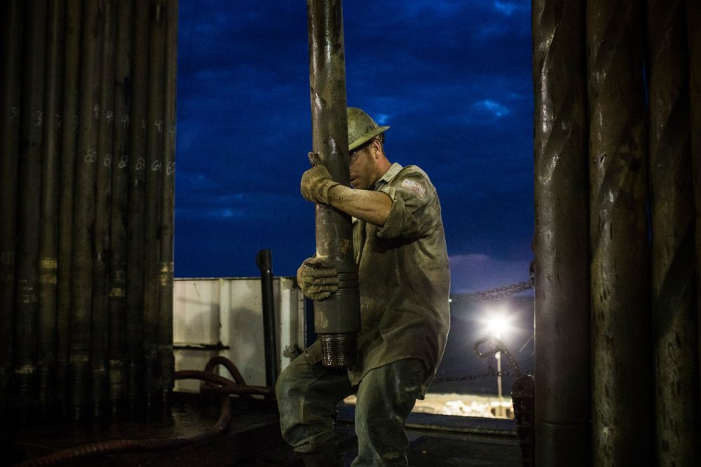 Oil prices are at a four year low. One of the contributing factors is the shale boom, as on the Bakken Shale in North Dakota. Pictured here Scott Berreth, a derrick hand for Raven Drilling, works on an oil rig drilling into the Bakken shale formation on July 28, 2013 outside Watford City, North Dakota. (Andrew Burton/Getty Images)