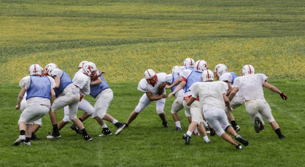 Steve Almond: &quot;What is a dangerous, insanely commercialized form of athletic combat doing in our public schools?&quot; Pictured:  Members of the Platteview High School football team practice in Springfield, Neb. (Nati Harnik/AP)