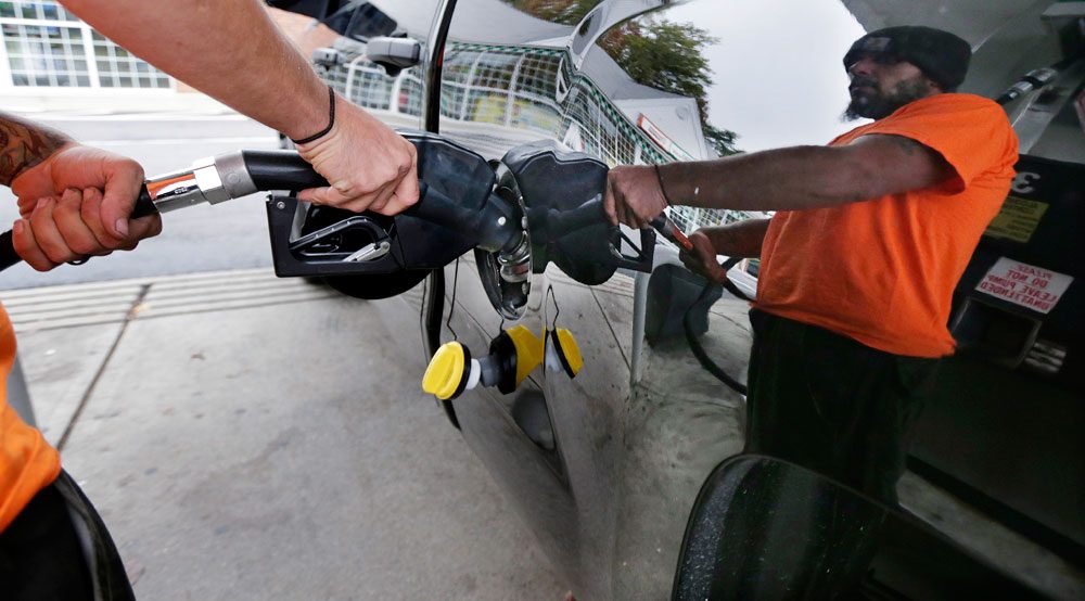Dana Ripley, of Winthrop, fills the gas tank of his truck in Andover on Sept. 30. (Charles Krupa/AP)