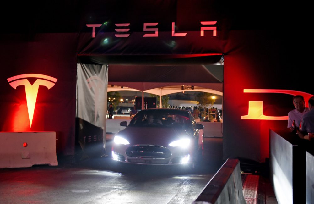 Tesla owners take a ride in the new Tesla &quot;D&quot; model electric sedan after Elon Musk, CEO of Tesla, unveiled the dual engine chassis of the new Tesla 'D' model at the Hawthorne Airport October 09, 2014 in Hawthorne, California. ( Kevork Djansezian/Getty Images)