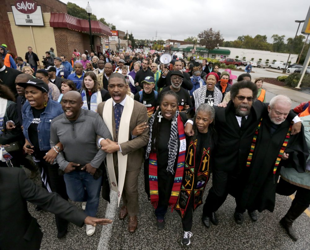 Protesters, including Cornel West, march to the Ferguson, Mo., police station, Monday, Oct. 13. (Charles Rex Arbogast/AP)