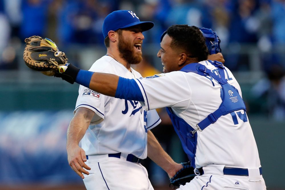Greg Holland #56 and Salvador Perez #13 of the Kansas City Royals celebrates their 2 to 1 win over the Baltimore Orioles to sweep the series in Game Four of the American League Championship Series at Kauffman Stadium on October 15, 2014 in Kansas City, Missouri. (Ed Zurga/Getty Images)