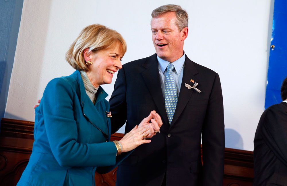 Democrat Martha Coakley and Republican Charlie Baker stand together at a Greater Boston Interfaith Organization candidates forum at Fourth Presbyterian Church in Boston on Sunday. (Michael Dwyer/AP)