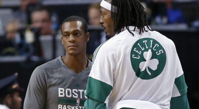 Peter May: &quot;There are Celtics’ fans out there who care about the team. But in the current New England sports solar system, the Celtics are whatever comes after Pluto.&quot; Pictured: Boston Celtics guard Rajon Rondo, left, talks with forward Gerald Wallace during a preseason game in Boston, Wednesday, Oct. 22, 2014. (Elise Amendola/AP)