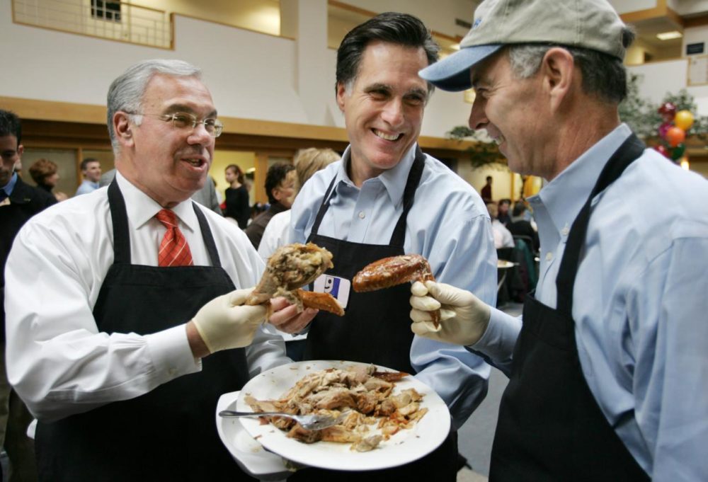 Mayor Menino, then-Massachusetts Gov. Mitt Romney, center, and NSTAR CEO Tom May compare turkey portions while taking a break from serving turkey at the Goodwill Thanks-For-Giving Dinner in Boston on Nov. 24, 2004. (Steven Senne/AP)