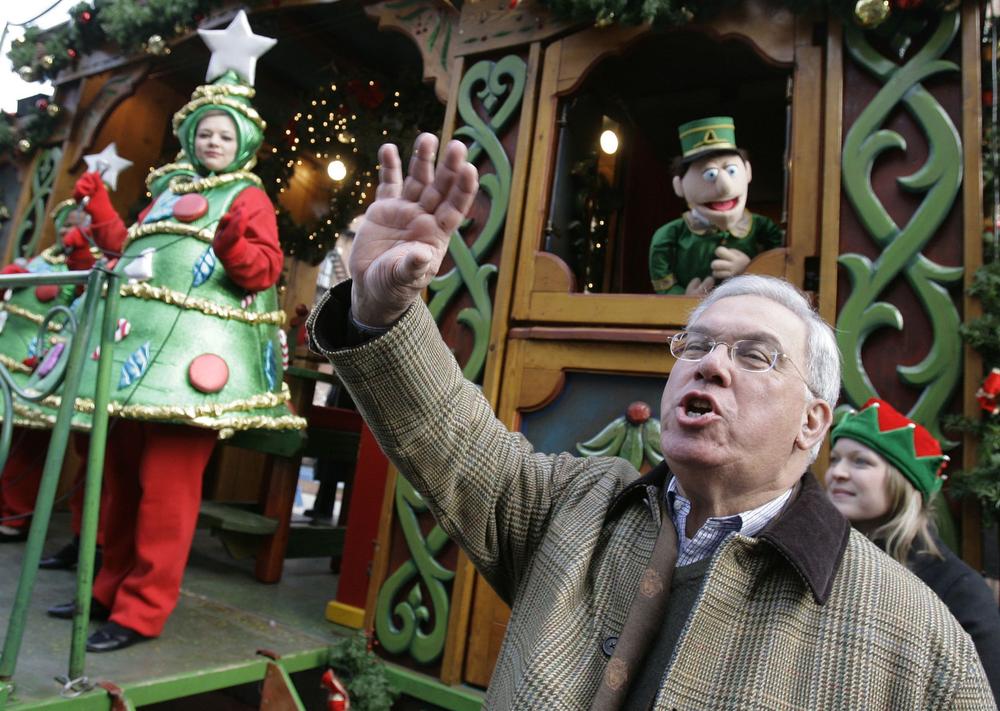 Boston Mayor Thomas Menino waves to the crowd during a Christmas tree lighting ceremony in the North End neighborhood of Boston in 2006. (Michael Dwyer/AP)