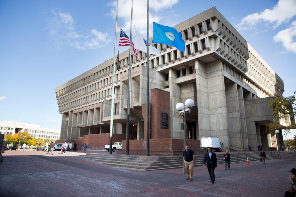 Flags fly at half mast in front of City Hall Thursday. Thomas Menino, Boston's longest-serving mayor, passed away Thursday morning after a battle with cancer. He was 71. (Jesse Costa/WBUR)