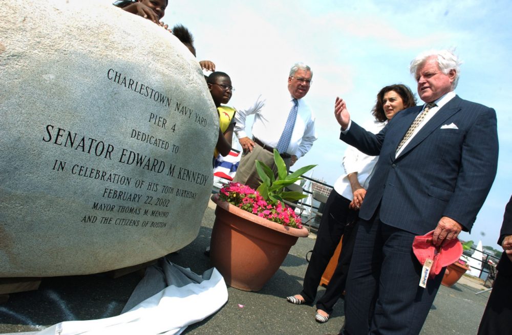 Sen. Edward M. Kennedy, D, Mass., right, admires a monument following the dedication of Pier 4 to Kennedy at the Charlestown Navy Yard in 2002. Kennedy is standing with his wife, Victoria Reggie Kennedy, and Boston Mayor Thomas Menino. (Lisa Poole/AP)