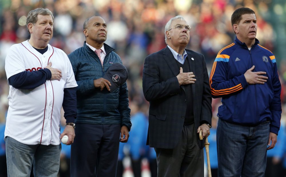 Founder of The One Fund Jim Gallagher, left, Massachusetts Gov. Deval Patrick, center left, former Boston mayor Tom Menino, center right, and current mayor Marty Walsh, right, stand on the field at Fenway Park for the playing of the national anthem during ceremonies marking the one-year anniversary of the Boston Marathon bombings before a baseball game between the Boston Red Sox and the Baltimore Orioles in Boston, Sunday, April 20, 2014. (Michael Dwyer/AP)