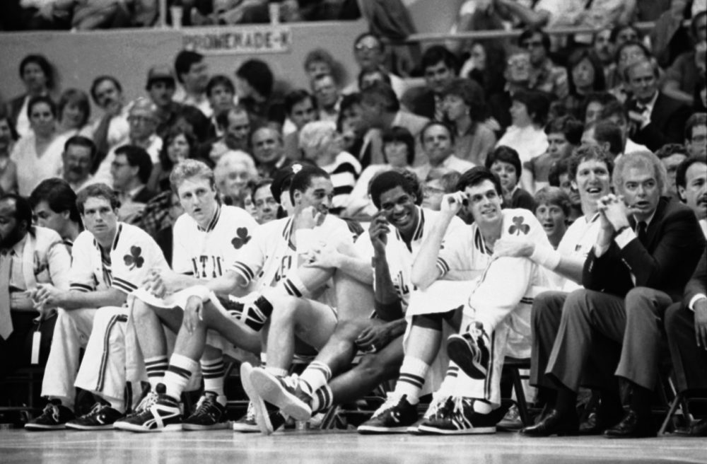 Four strangers to the Celtics bench react as they get to sit out the fourth quarter of a playoff rout while the rest of the team carries on to a Boston victory over the Atlanta Hawks, 132-99, Tuesday, May 6, 1986 in Boston. (AP)