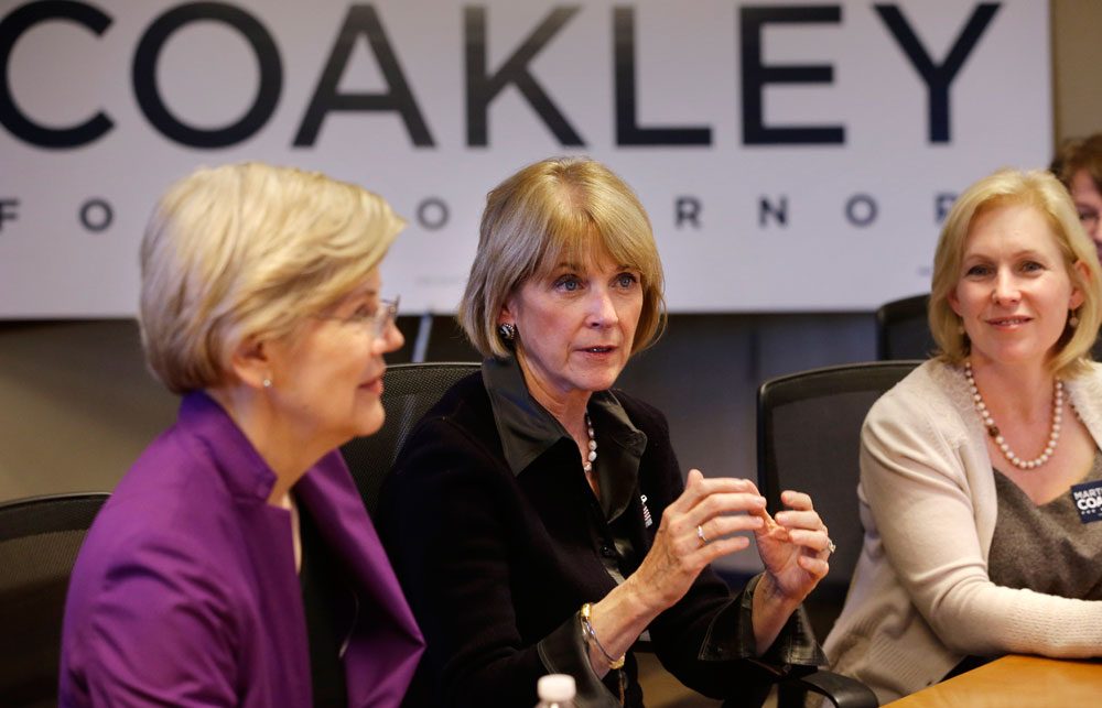 Democratic gubernatorial candidate Martha Coakley, center, speaks during a roundtable discussion as U.S. Sen. Elizabeth Warren, D-Mass., left, and U.S. Sen. Kirsten Gillibrand, D-N.Y., right, look on at offices of the Service Employees International Union on Sept. 14 in Boston. (Steven Senne/AP)