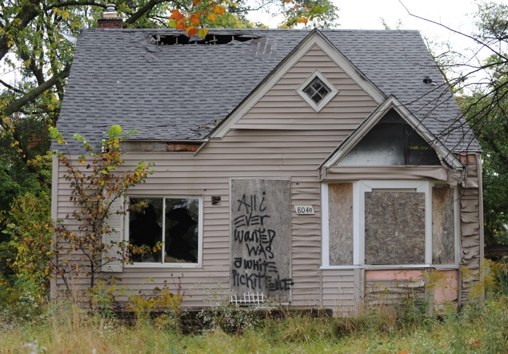 An abandoned home seen September 30, 2013 in Detroit, Michigan, is decorated with a piece of fencing and graffiti which declares &quot;All I ever wanted was a white picket fence.&quot; (Mira Oberman/AFP/Getty Images)