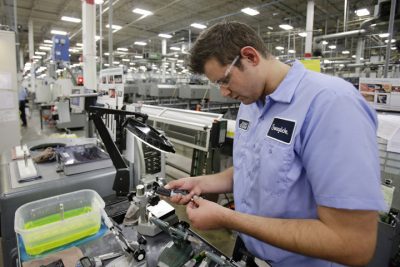 This Tuesday, Sept. 9, 2014 photo shows Jonah Devorak testing the dimensions on a high-pressure valve at Swagelok Co. in Strongsville, Ohio. (AP)