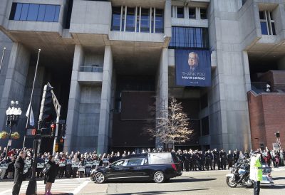 The procession passes City Hall in Boston. (Elise Amendola/AP)