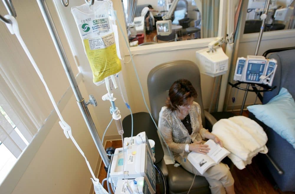 Cancer patient Terry Meyer reads a book while receiving chemotherapy treatment on June 21, 2006 in San Francisco. (Justin Sullivan/Getty Images)