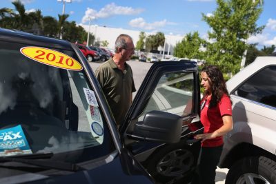 Natalie Pena (right) shows vehicles to Ruben Mendoza as he shops for vehicles at the Toyota of Deerfield dealership on October 2, 2014 in Deerfield Beach, Florida. (Joe Raedle/Getty Images)