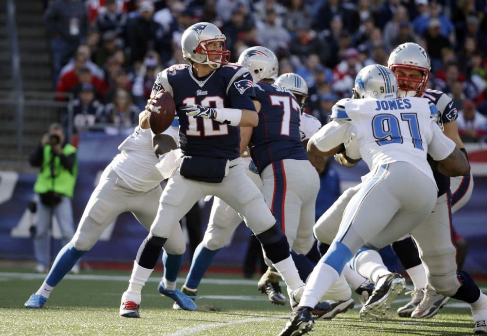 Patriots quarterback Tom Brady passes against the rush by Detroit Lions defensive end Jason Jones in the first half. (Steven Senne/AP)