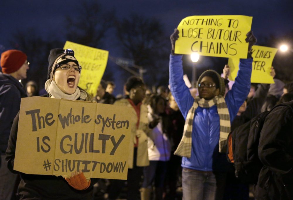 Protesters block streets after the announcement of the grand jury decision, Monday, Nov. 24, 2014, in St. Louis, Mo. A grand jury has decided not to indict Ferguson police officer Darren Wilson in the shooting death of 18-year-old Michael Brown. (Jeff Roberson/AP)