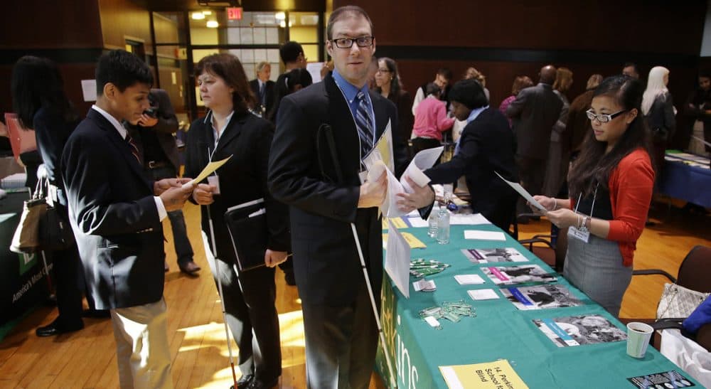 The unemployment rate for qualified blind job applicants is a staggering 75 percent. Massachusetts is in a unique position to change that. Pictured: Jeff Paquette, center, a graduate of Johnson and Wales University, waits to speak to a recruiter during a job fair for the visually impaired at the Radcliffe Institute in Cambridge, Mass., Thursday, Oct. 24, 2013. Paquette is searching for a position in the hospitality industry.(Stephan Savoia/AP)