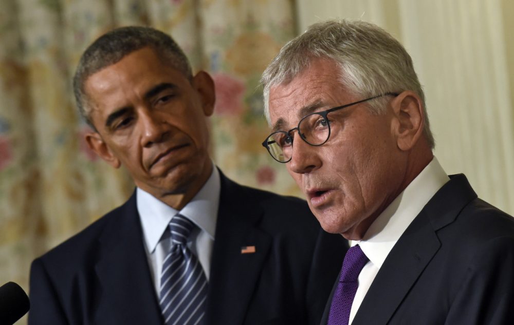 President Barack Obama, left, listens as Defense Secretary Chuck Hagel, right, talks about his resignation. (AP)