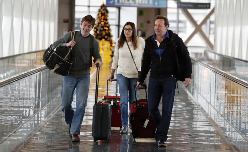 Travelers Passengers walk in a terminal at Logan International Airport in Boston on Wednesday. (Michael Dwyer/AP)