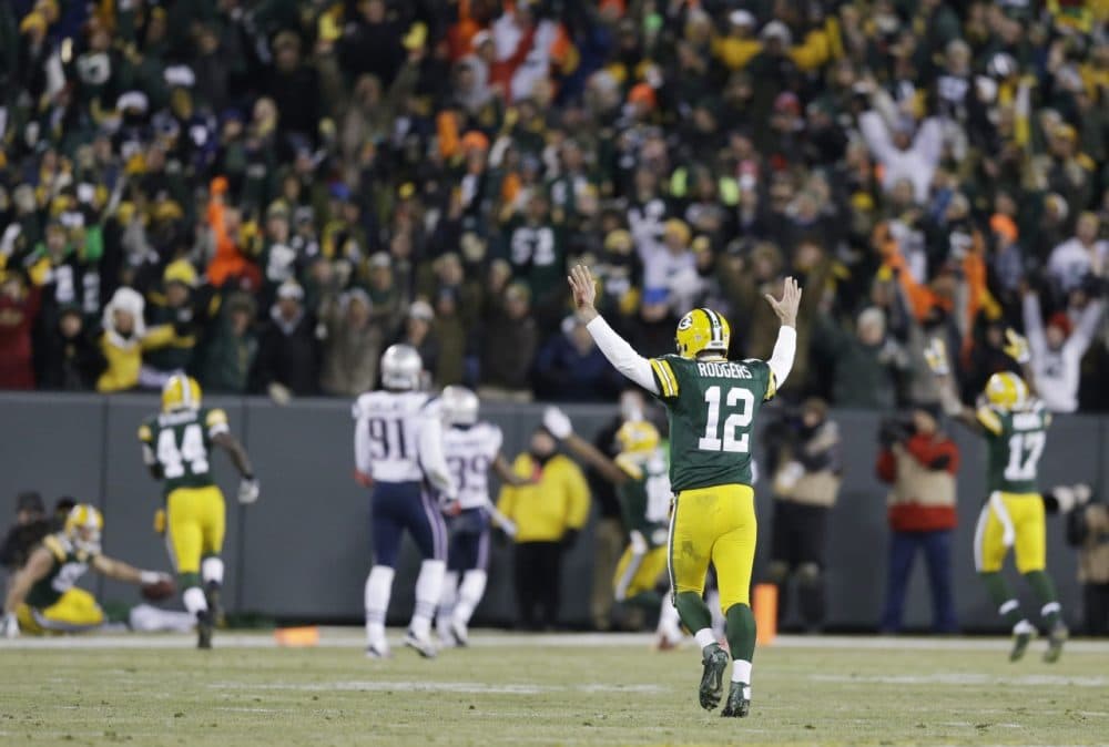 Green Bay Packers quarterback Aaron Rodgers (12) celebrates a 45-yard touchdown pass to Jordy Nelson during the waning moments of the first half against the New England Patriots Sunday in Green Bay, Wis. (Tom Lynn/AP)