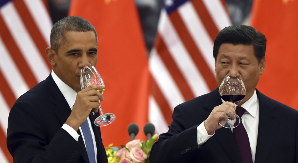 U.S. President Barack Obama, left, and Chinese President Xi Jinping drink a toast at a lunch banquet in the Great Hall of the People in Beijing Wednesday, Nov. 12, 2014.  The United States and China pledged Wednesday to take ambitious action to limit greenhouse gases, aiming to inject fresh momentum into the global fight against climate change ahead of high-stakes climate negotiations next year. (Greg Baker/ AP)