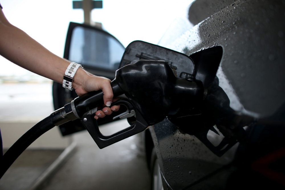 This is a photograph of a man pumping gas. (Hoe Raedle/Getty Images)
