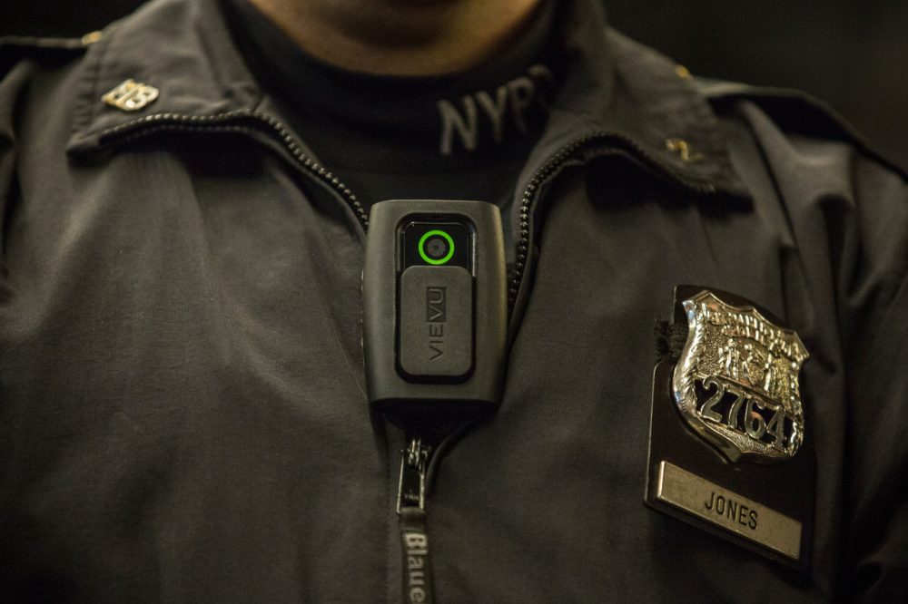 Officer Joshua Jones demonstrates how to use and operate a body camera during a press conference on December 3, 2014 in New York City. (Andrew Burton/Getty Images)