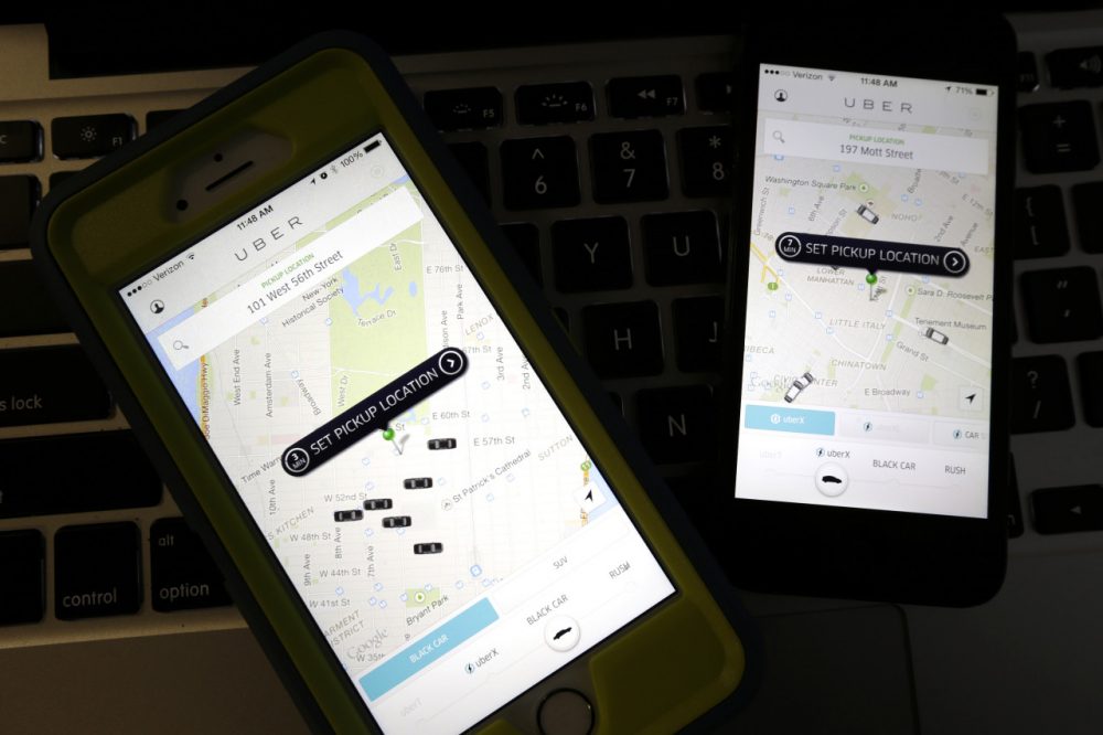 Smartphones display Uber car availability in New York in this November file photo. (Julio Cortez/AP)
