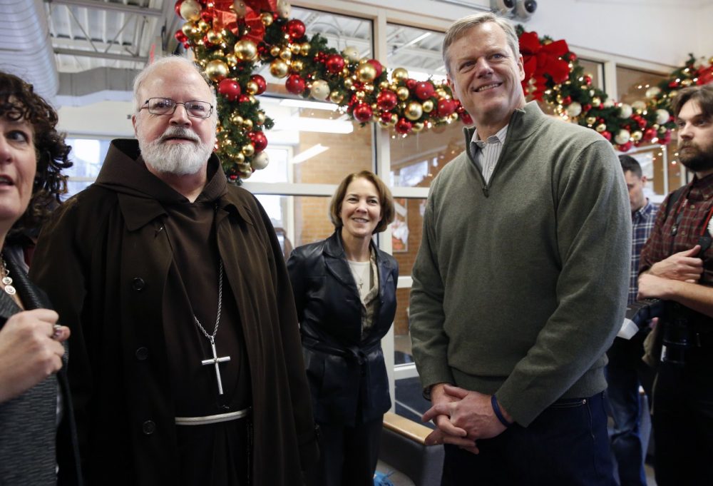 Archbishop of Boston Sean O'Malley, left, and Gov.-elect Charlie Baker stand together before serving meals at the Pine Street Inn homeless shelter in Boston on  Wednesday. (Michael Dwyer/AP)