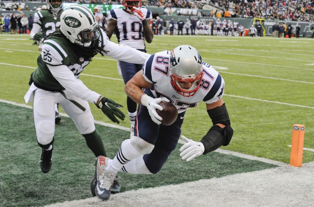 New England Patriots tight end Rob Gronkowski (87) scores a touchdown as New York Jets' Calvin Pryor (25) tackles him during the first half of Sunday's game on Dec. 21, 2014, in East Rutherford, N.J. (Bill Kostroun/AP)