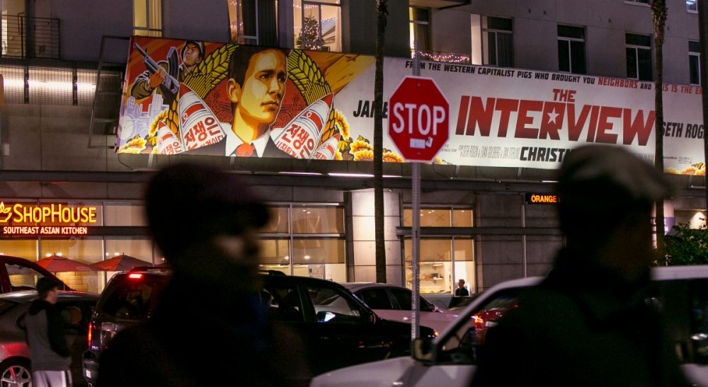 People walk past a banner for &quot;The Interview&quot;at Arclight Cinemas, Wednesday, Dec. 17, 2014, in the Hollywood section of Los Angeles. A U.S. official says North Korea perpetrated the unprecedented act of cyberwarfare against Sony Pictures that exposed tens of thousands of sensitive documents and escalated to threats of terrorist attacks that ultimately drove the studio to cancel all release plans for the film at the heart of the attack, &quot;The Interview.&quot; (Damian Dovarganes/AP)