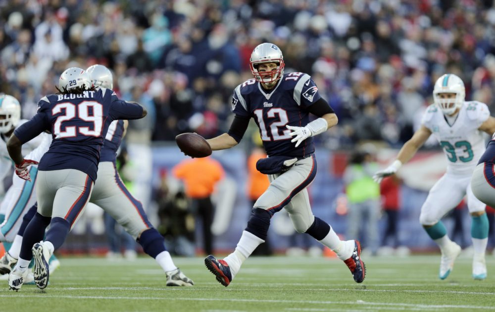 New England Patriots quarterback Tom Brady (12) fakes a handoff to running back LeGarrette Blount (29) in the second half of an NFL football game against the Miami Dolphins Sunday. (Charles Krupa/AP)