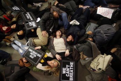 Protesters rallying against a grand jury's decision not to indict the police officer involved in the death of Eric Garner stage a &quot;die-in&quot; at the Apple Store on Fifth Avenue, Friday, Dec. 5, 2014, in New York. (AP)