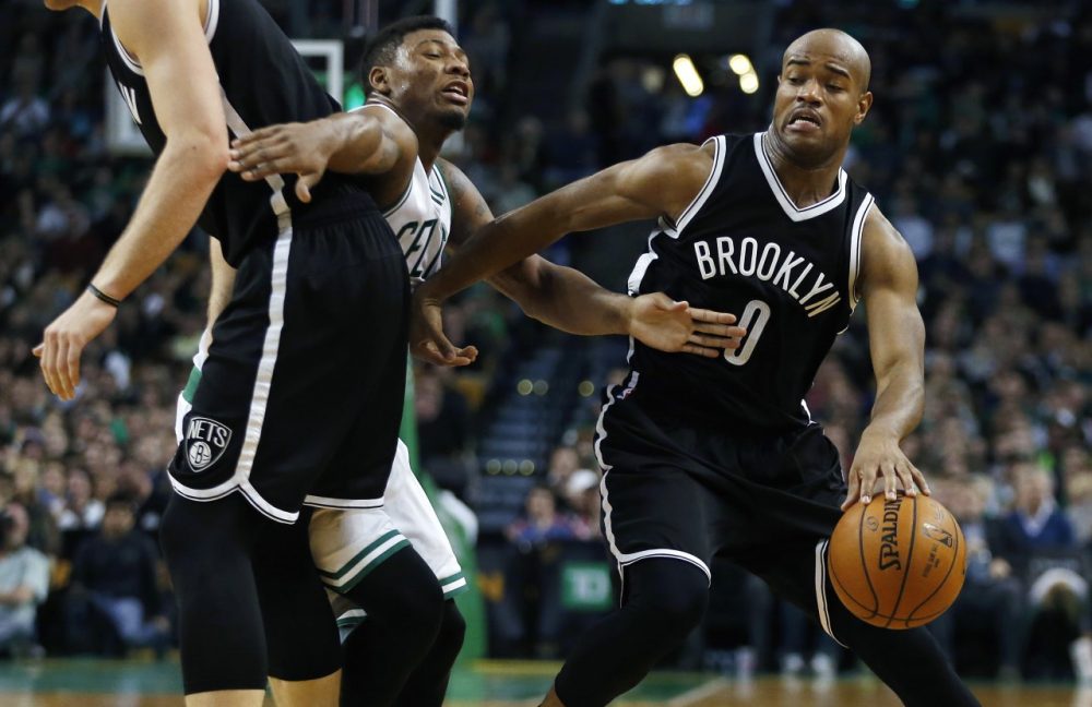 Brooklyn Nets' Jarrett Jack (0) drives past Boston Celtics' Marcus Smart (36), center, as the Nets' Mason Plumlee, left, sets up a screen in the third quarter of an NBA basketball game in Boston, Friday. (Michael Dwyer/AP)