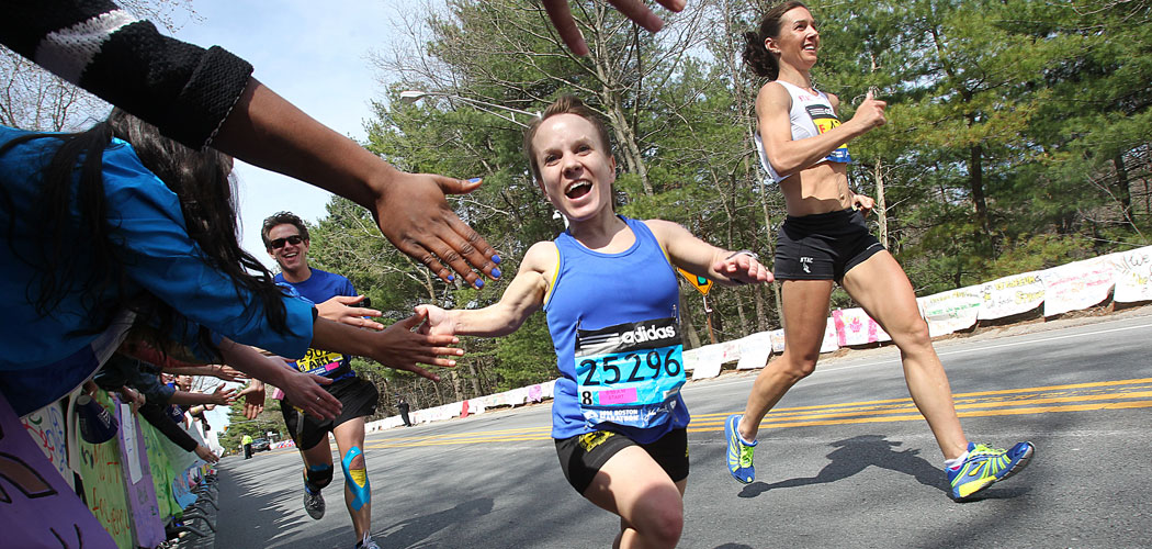 Juli Windsor, foreground, 27, returned to the Boston Marathon in 2014 after being stopped less than a mile shy of the finish after two bombs exploded at last year’s race. Reporter and documentarian David Abel is running to the left. (Courtesy of Suzanne Kreiter/The Boston Globe)