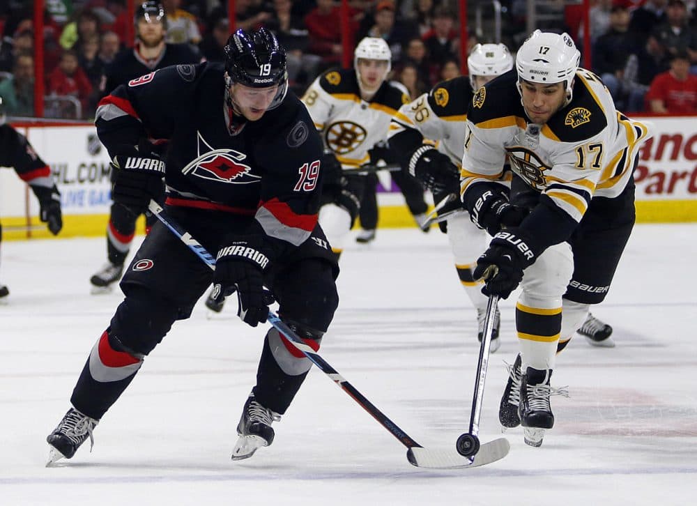 Carolina Hurricanes' Jiri Tlusty (19) of Czech Republic,  and Boston Bruins' Milan Lucic (17) vie for the puck during the second period of an NHL hockey game in Raleigh, N.C. on Sunday. (Karl B DeBlaker/AP)