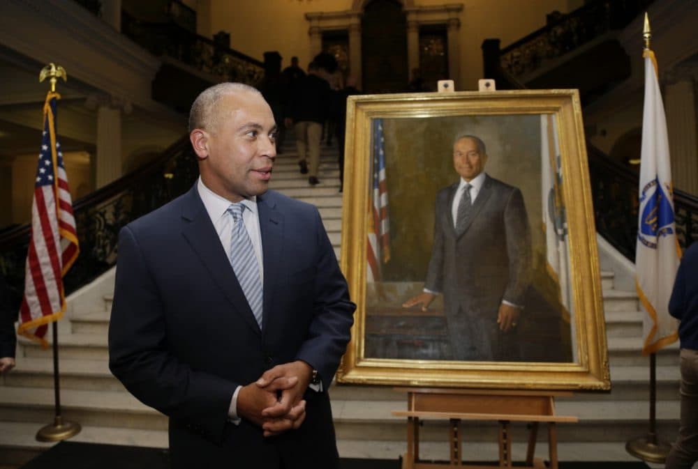 Gov. Deval Patrick stands near his official state portrait following ceremonies Sunday at the State House. (Steven Senne/AP)